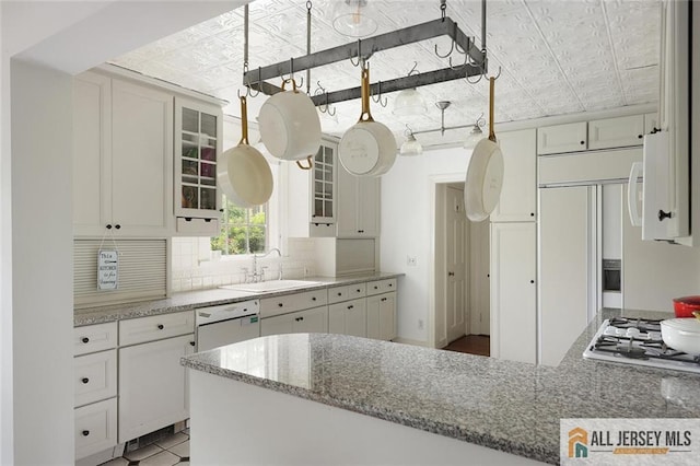 241 E Chestnut Ave, Metuchen, NJ 08840 - kitchen featuring an ornate ceiling, white appliances, a sink, white cabinets, and glass insert cabinets