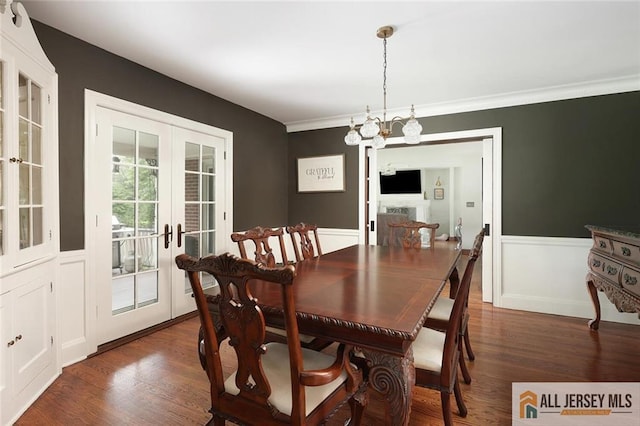 241 E Chestnut Ave, Metuchen, NJ 08840 - dining space featuring french doors, wood finished floors, a chandelier, wainscoting, and ornamental molding