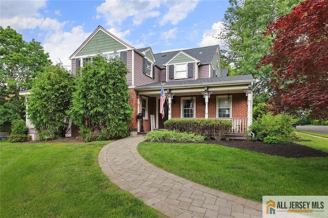 241 E Chestnut Ave, Metuchen, NJ 08840 - view of front of property with covered porch, a front yard, and brick siding