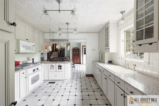 241 E Chestnut Ave, Metuchen, NJ 08840 - kitchen featuring a sink, white appliances, an ornate ceiling, a peninsula, and backsplash