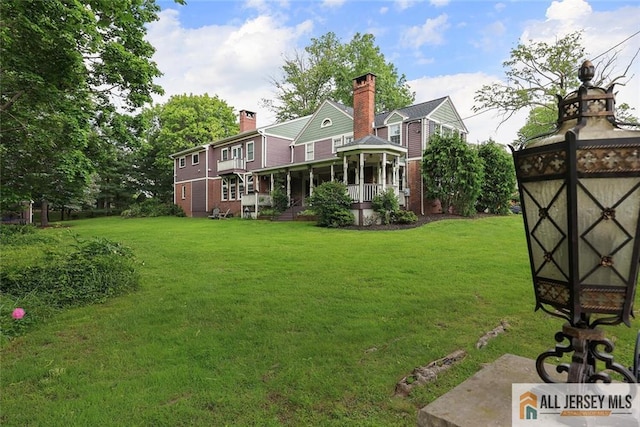 241 E Chestnut Ave, Metuchen, NJ 08840 - rear view of property with a lawn and brick siding
