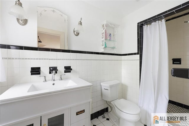 241 E Chestnut Ave, Metuchen, NJ 08840 - bathroom with tile walls, vanity, toilet, a tile shower, and tile patterned floors