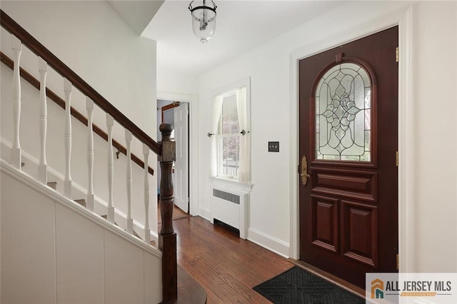 241 E Chestnut Ave, Metuchen, NJ 08840 - foyer entrance featuring radiator heating unit, dark wood-style flooring, stairway, and baseboards