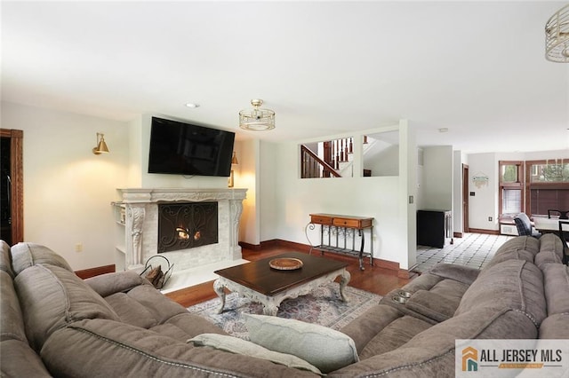 241 E Chestnut Ave, Metuchen, NJ 08840 - living room featuring baseboards, stairs, a fireplace, and wood finished floors