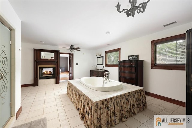 241 E Chestnut Ave, Metuchen, NJ 08840 - full bath featuring tile patterned floors, a bath, a multi sided fireplace, ceiling fan, and baseboards