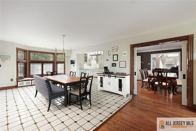 241 E Chestnut Ave, Metuchen, NJ 08840 - dining room featuring a chandelier, plenty of natural light, baseboards, and wood finished floors