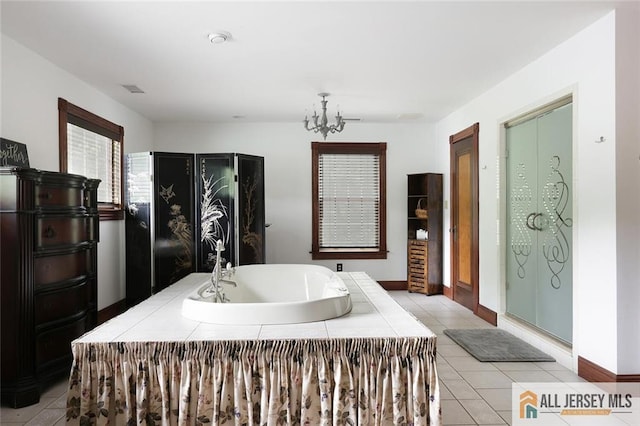 241 E Chestnut Ave, Metuchen, NJ 08840 - full bath featuring a bath, a chandelier, tile patterned floors, and baseboards