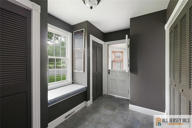 241 E Chestnut Ave, Metuchen, NJ 08840 - doorway featuring baseboards and dark tile patterned floors