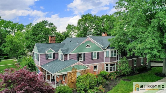 241 E Chestnut Ave, Metuchen, NJ 08840 - back of house with a chimney, brick siding, and a lawn