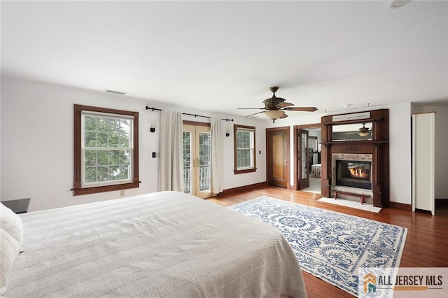 241 E Chestnut Ave, Metuchen, NJ 08840 - bedroom featuring access to outside, wood finished floors, a glass covered fireplace, and baseboards