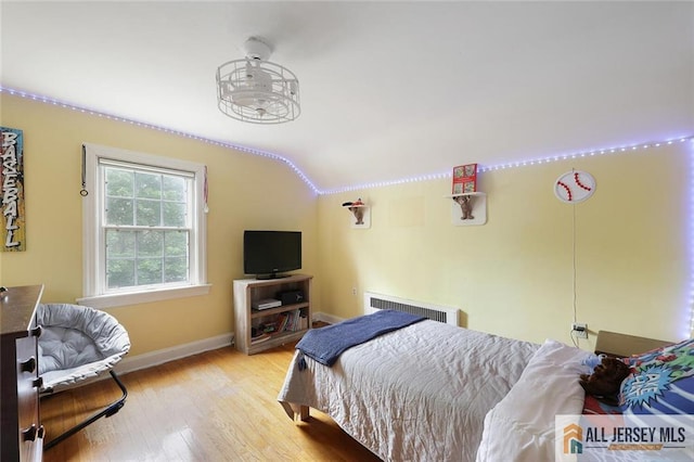 241 E Chestnut Ave, Metuchen, NJ 08840 - bedroom featuring lofted ceiling, wood finished floors, baseboards, and radiator