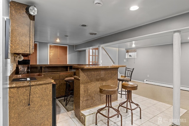 15 Cutter Ave, Fords, NJ 08863 - kitchen featuring light tile patterned floors, a kitchen breakfast bar, recessed lighting, a peninsula, and dark countertops