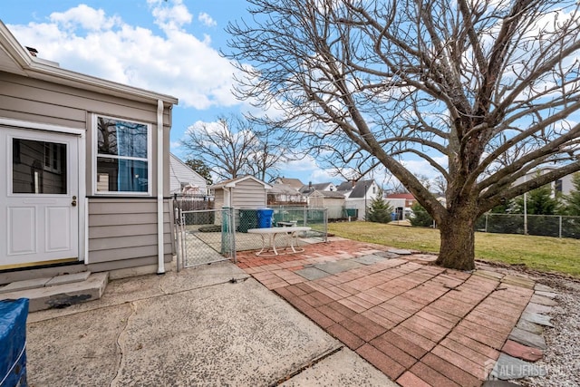 view of patio with an outbuilding and fence