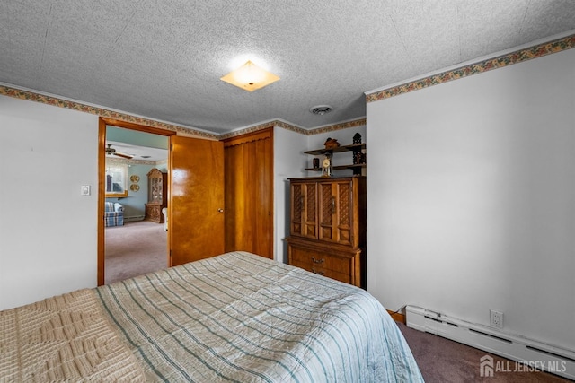 carpeted bedroom with visible vents, baseboard heating, and a textured ceiling