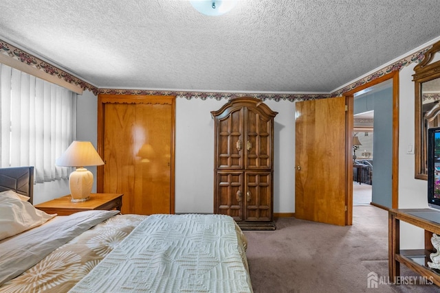 bedroom with baseboards, carpet floors, and a textured ceiling