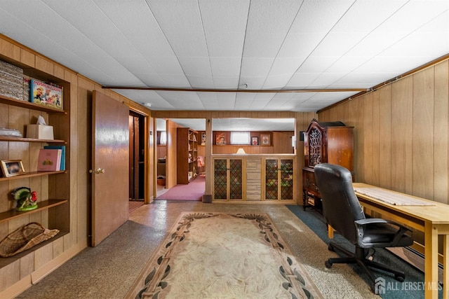 office space featuring built in features and wood walls