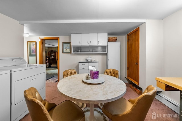 carpeted dining space with baseboard heating and washer and clothes dryer