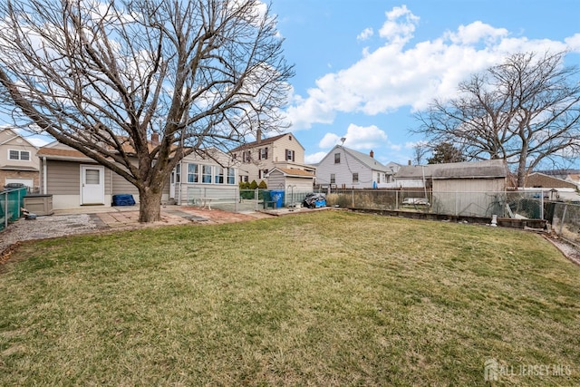 view of yard featuring a residential view, a patio, a fenced backyard, and a gate