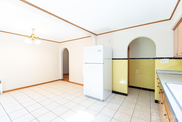 2624 Tremley Point Rd, Linden, NJ 07036 - kitchen featuring freestanding refrigerator, crown molding, arched walkways, light countertops, and a chandelier