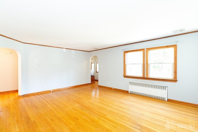 2624 Tremley Point Rd, Linden, NJ 07036 - unfurnished room with radiator, arched walkways, ornamental molding, light wood-style floors, and baseboards