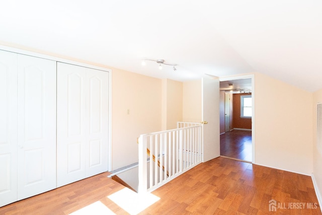 2624 Tremley Point Rd, Linden, NJ 07036 - corridor featuring wood finished floors, an upstairs landing, and vaulted ceiling