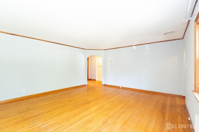 2624 Tremley Point Rd, Linden, NJ 07036 - spare room featuring arched walkways, light wood finished floors, crown molding, and baseboards
