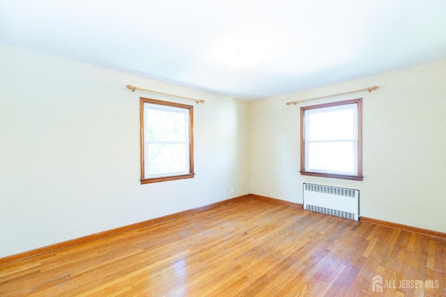 2624 Tremley Point Rd, Linden, NJ 07036 - spare room with radiator, light wood-style flooring, and baseboards