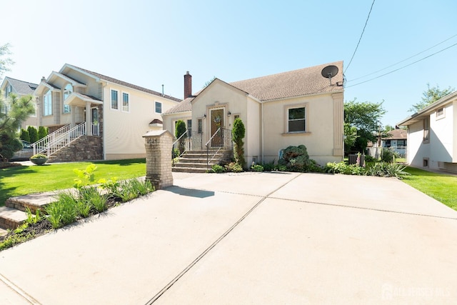 2624 Tremley Point Rd, Linden, NJ 07036 - view of front of property featuring a chimney, a front lawn, and stucco siding