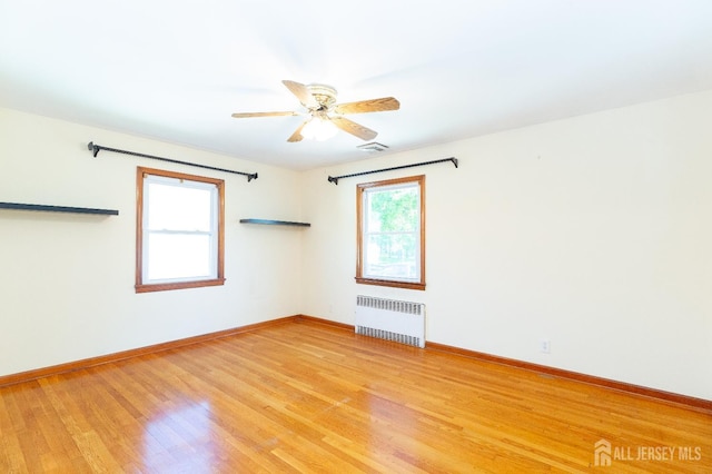 2624 Tremley Point Rd, Linden, NJ 07036 - empty room featuring radiator, ceiling fan, light wood-style floors, and baseboards