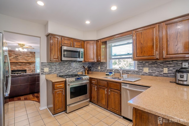 55 Cambridge Way, West Windsor, NJ 08550 - kitchen featuring appliances with stainless steel finishes, light tile patterned floors, brown cabinetry, decorative backsplash, and recessed lighting