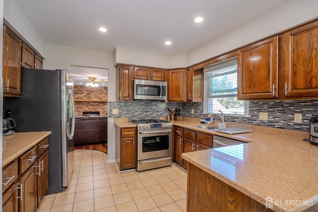 55 Cambridge Way, West Windsor, NJ 08550 - kitchen with stainless steel appliances, light tile patterned floors, a sink, backsplash, and ceiling fan