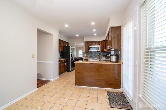 55 Cambridge Way, West Windsor, NJ 08550 - kitchen featuring appliances with stainless steel finishes, healthy amount of natural light, a peninsula, light tile patterned floors, and recessed lighting