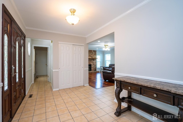 55 Cambridge Way, West Windsor, NJ 08550 - entryway with a brick fireplace, light tile patterned floors, ornamental molding, a ceiling fan, and baseboards