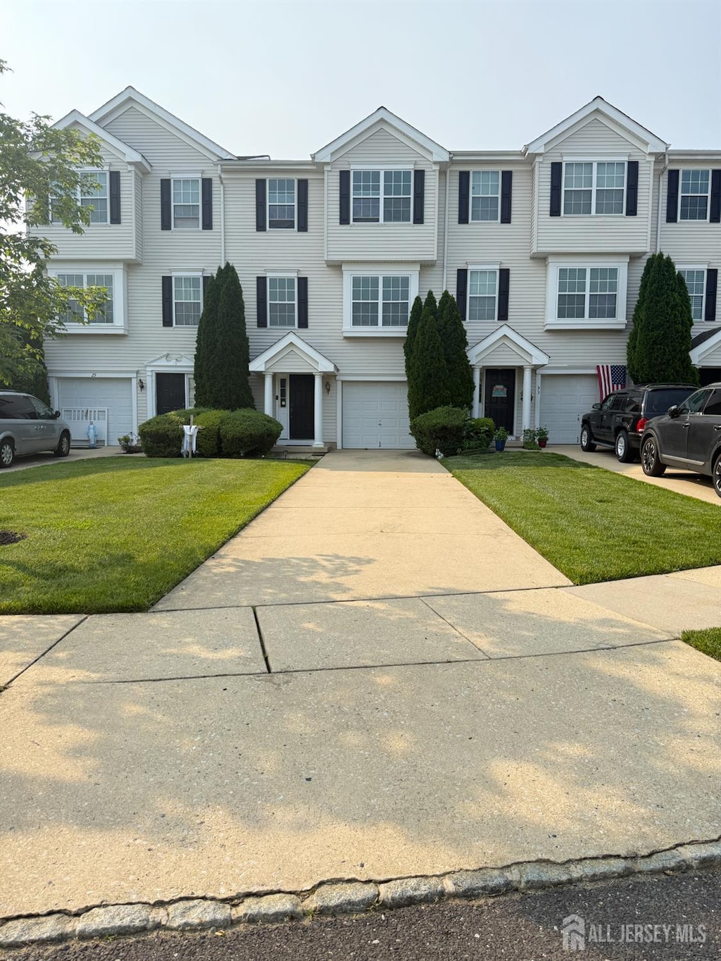 31 Highgrove Ct, West Deptford, NJ 08086 - view of front of property with an attached garage, driveway, and a front lawn