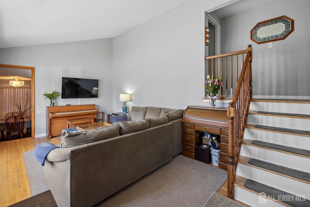 living area featuring stairway, hardwood / wood-style floors, and lofted ceiling