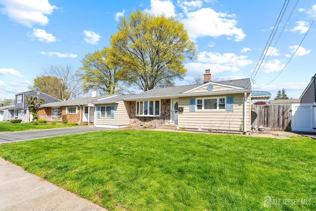 view of front of home featuring a chimney and asphalt driveway