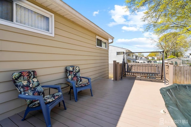 wooden terrace featuring fence