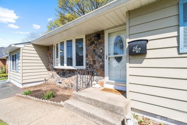 view of exterior entry featuring stone siding