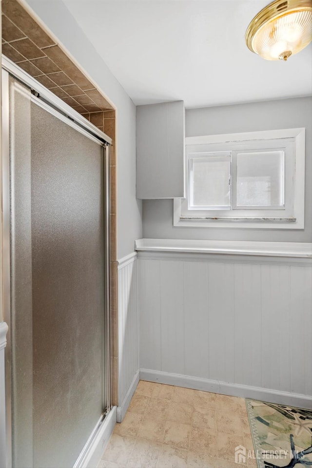 kitchen featuring wainscoting and a decorative wall