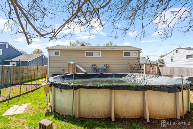 rear view of property with a fenced backyard