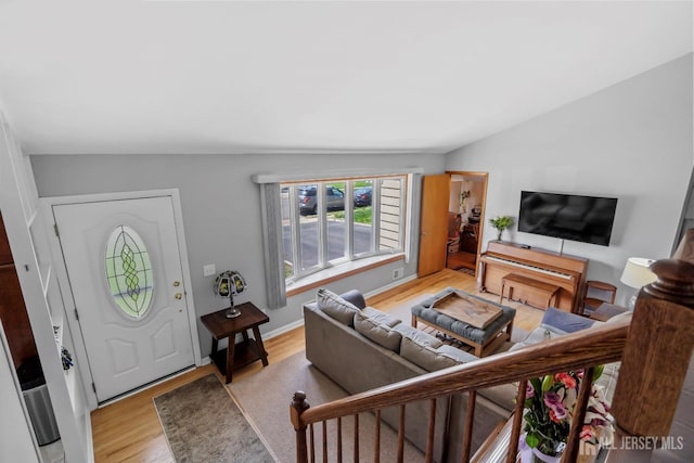 living room with wood finished floors and lofted ceiling