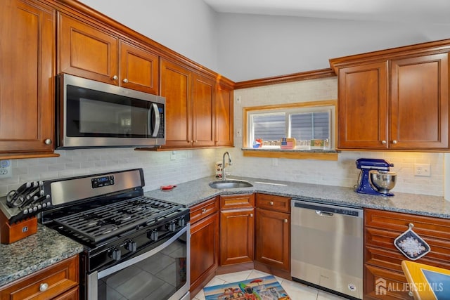 69 Claridge Pl, Colonia, NJ 07067 - kitchen featuring appliances with stainless steel finishes, a sink, stone countertops, backsplash, and light tile patterned floors
