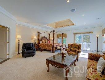 carpeted bedroom featuring crown molding