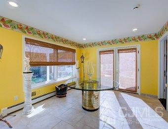 interior space with tile patterned floors and a baseboard heating unit