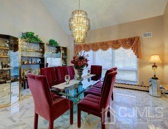 dining room featuring an inviting chandelier and lofted ceiling