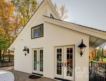 view of property exterior featuring french doors and an outdoor structure