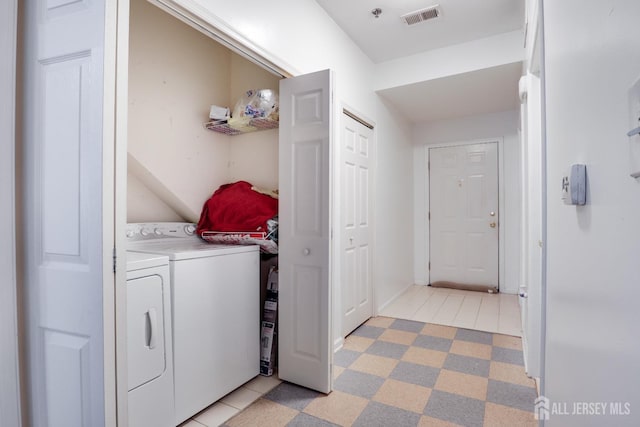 128 Remsen Ave Unit A, New Brunswick, NJ 08901 - laundry room with washer and dryer and light tile patterned flooring