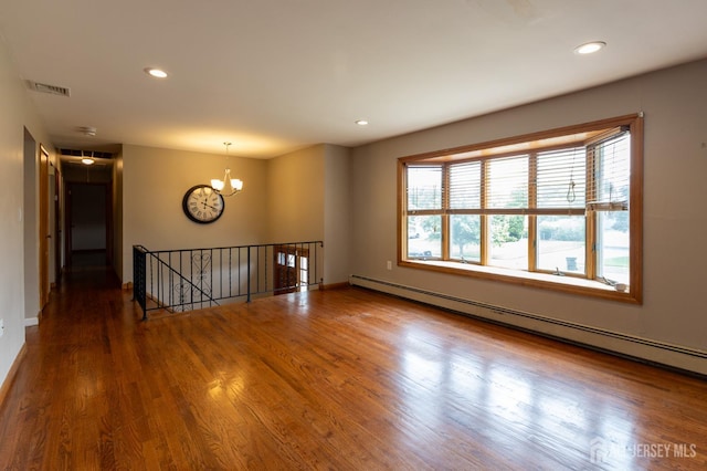 23 Little Brook Ln, Monroe, NJ 08831 - empty room with baseboard heating, a chandelier, wood finished floors, recessed lighting, and baseboards