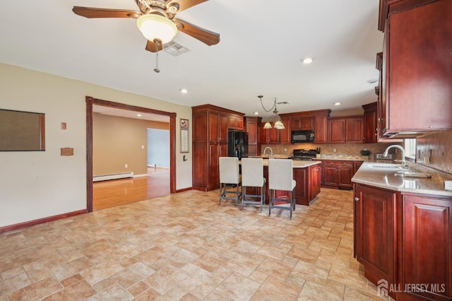 23 Little Brook Ln, Monroe, NJ 08831 - kitchen with black appliances, a baseboard heating unit, a sink, light countertops, and recessed lighting