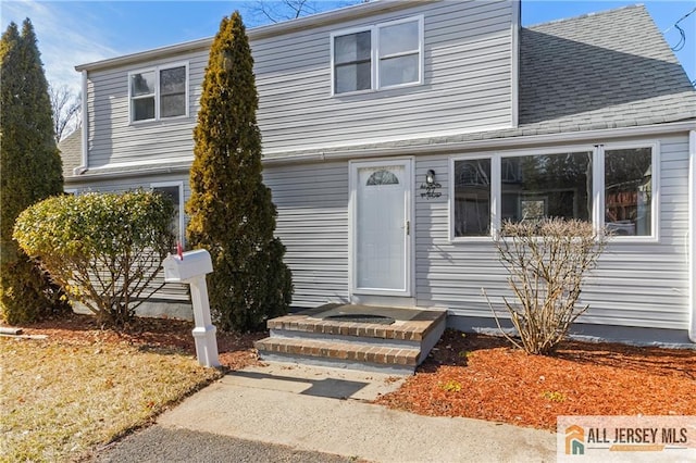 view of front of house featuring a shingled roof